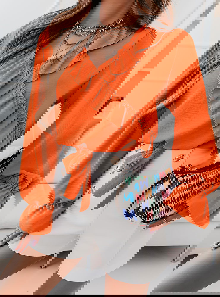 Pomarańczowa bluzka z falbankami przy...