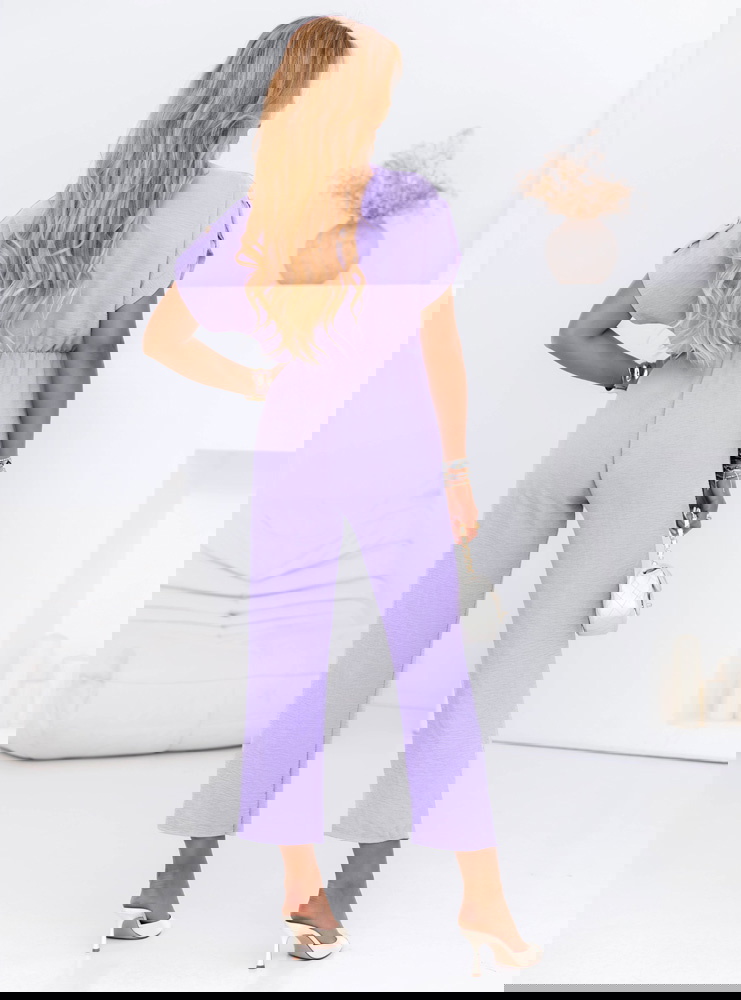 Liliowy kombinezon z guzikami na...