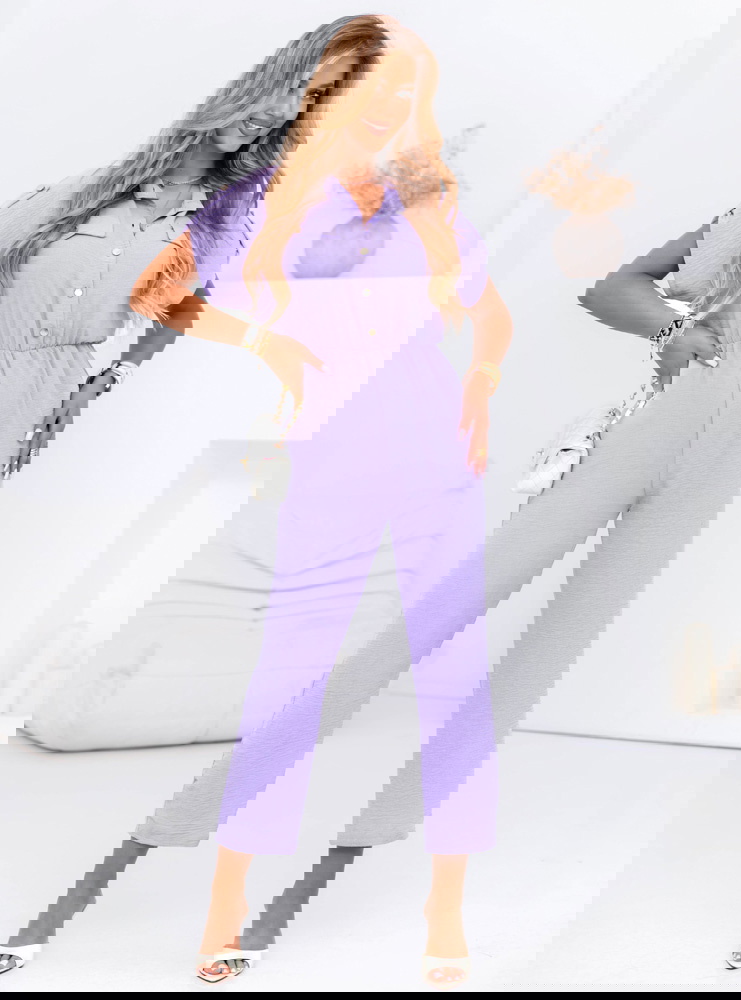 Liliowy kombinezon z guzikami na...