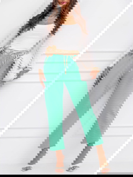 Miętowe spodnie z ozdobnym...