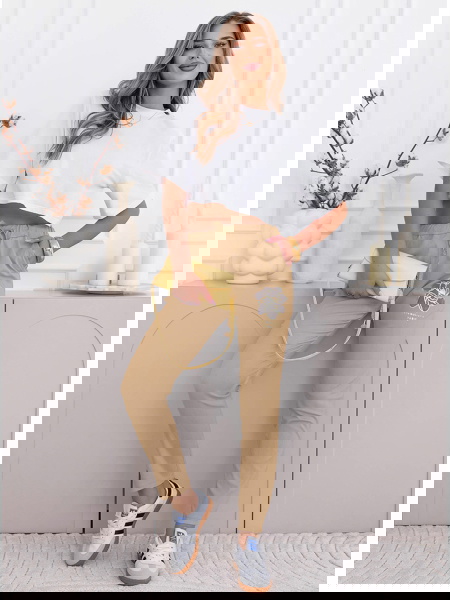 Beżowe spodnie z ozdobnym...